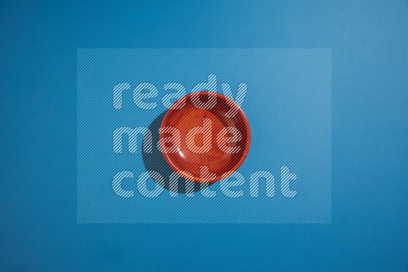 brown bowl on blue background