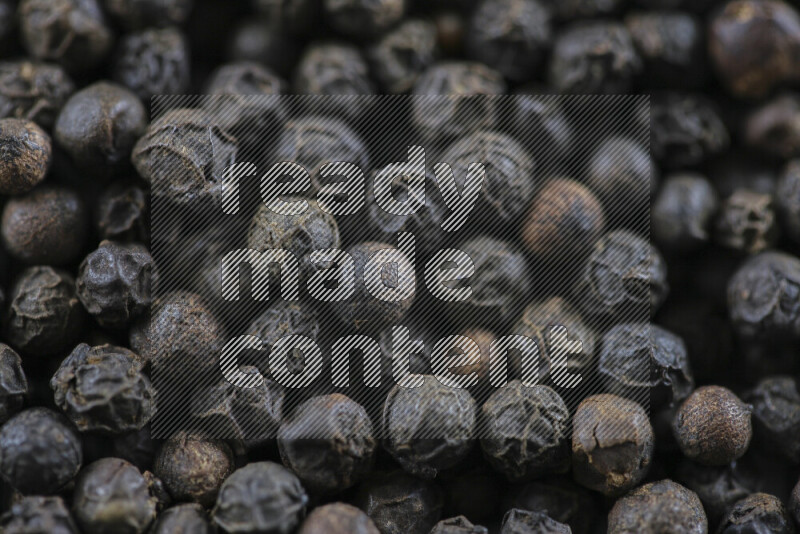 Black pepper beads on white background