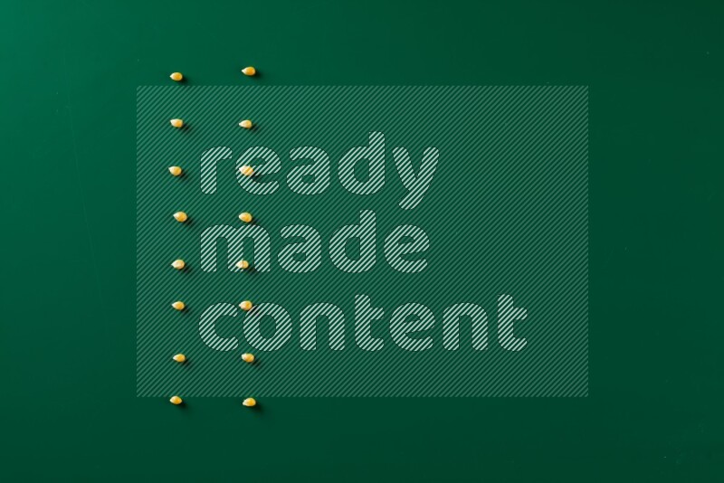 Popcorn seeds on a green background in a top view shot