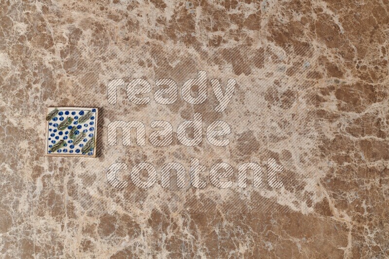A decorative coaster on beige marble background