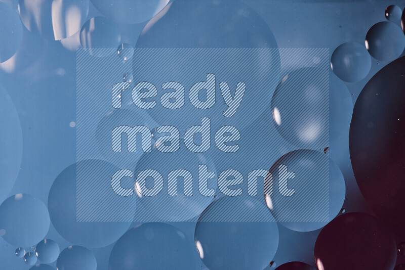 Close-ups of abstract oil bubbles on water surface in shades of blue and purple