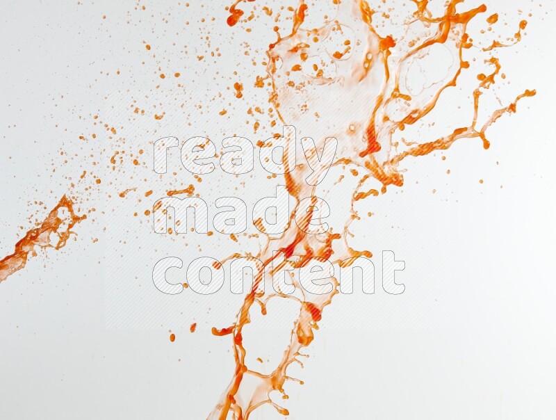 Orange liquid splash and drops on white background