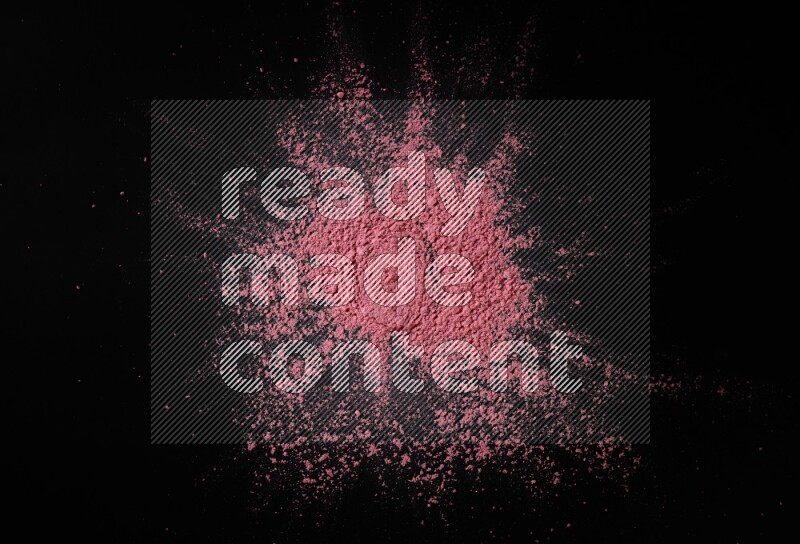 Red powder on black background