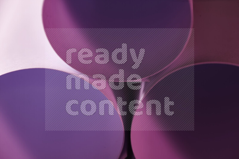 The image shows an abstract paper art with circular shapes in varying shades of pink