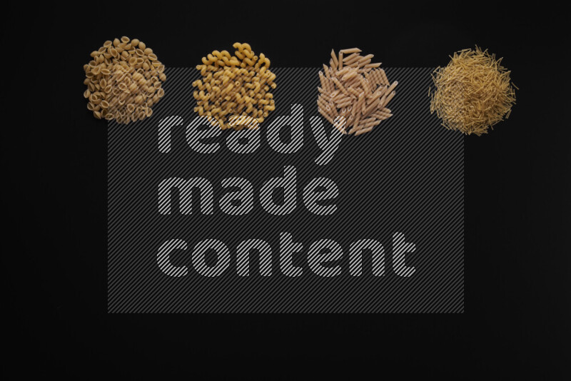 Different pasta types in 4 bunches on black background