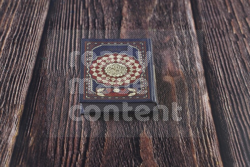 Quran with a prayer beads on wooden background