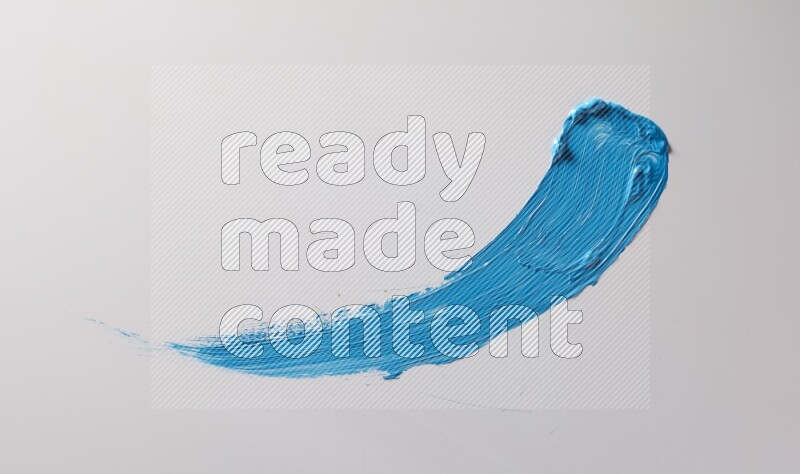 A single blue curved brush stroke on a white background