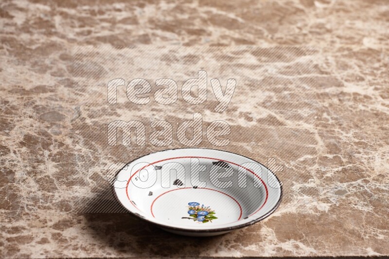 A vintage metal plate on beige marble background