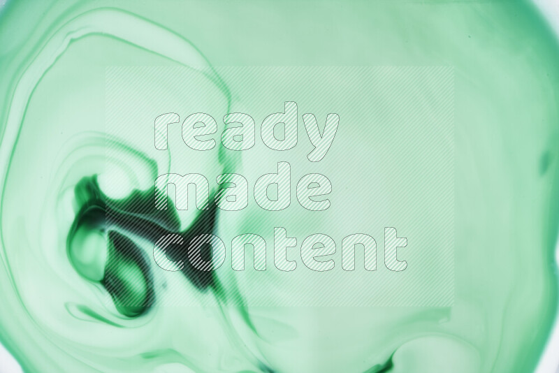 A close-up of abstract swirling patterns in green gradients