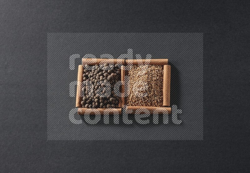 2 squares of cinnamon sticks full of mustard seeds and allspice on black flooring