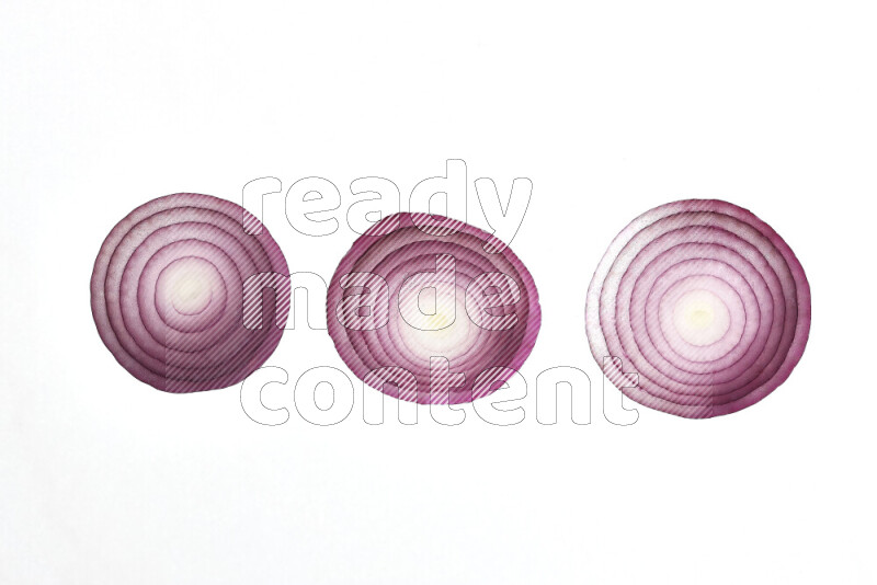 Onion slices on illuminated white background