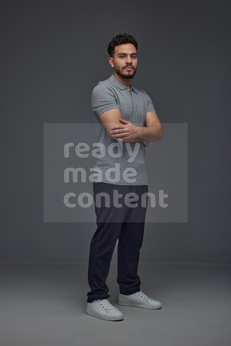 A man wearing casual making multi stand poses  eye level on a gray background