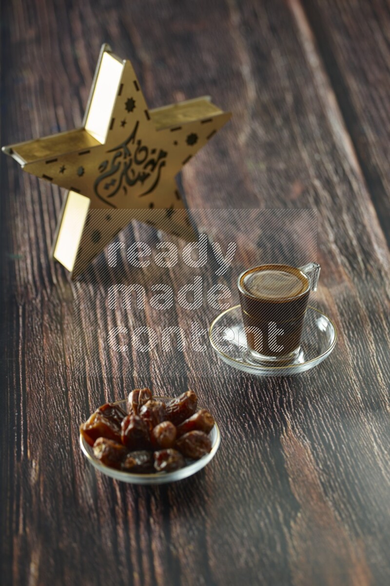 A wooden golden star lantern with different drinks, dates, nuts, prayer beads and quran on brown wooden background