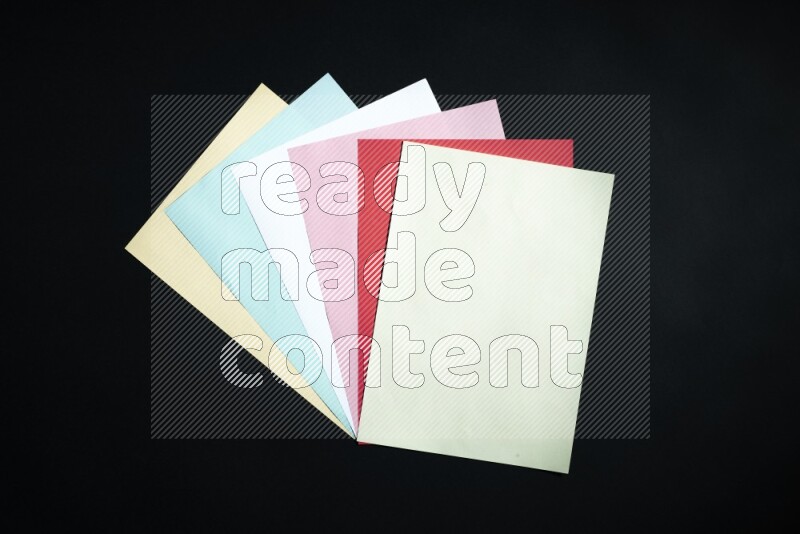 Multicolored paper sheet on black background