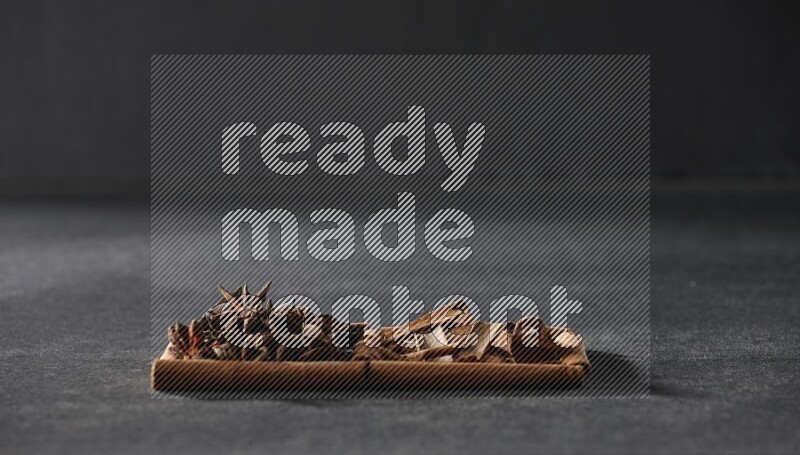 2 squares of cinnamon sticks full of star anise and cinnamon on black flooring