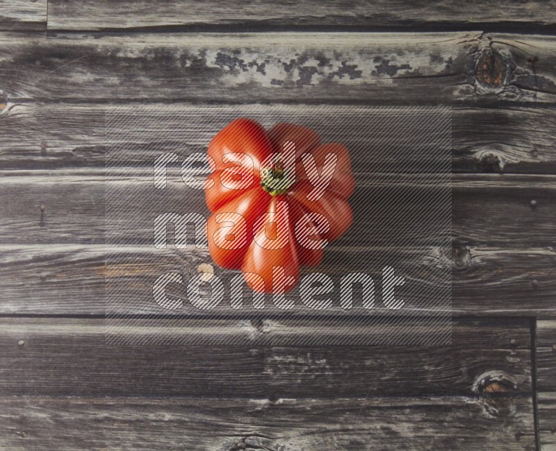 Single Tipview Heirloom Tomato on grey wooden background