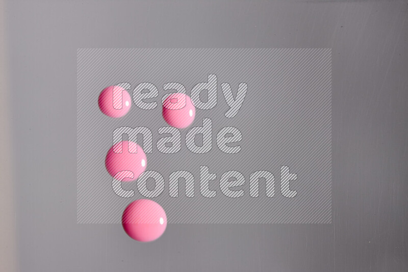Close-ups of abstract pink paint droplets on the surface