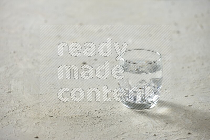 Cold drinks in a glass cup such as water, tamarind, qamar eldin, sobia, milk and hibiscus on textured white background