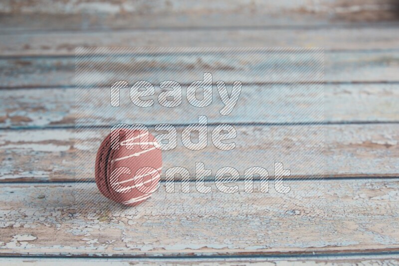 45º Shot of Red Poppy Flower macaron on light blue wooden background