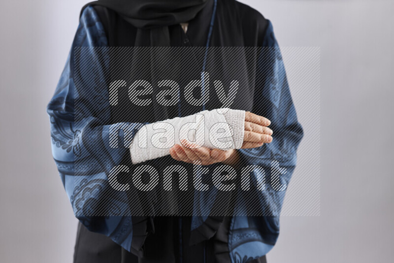 Woman with a bandaged hand and arm sling