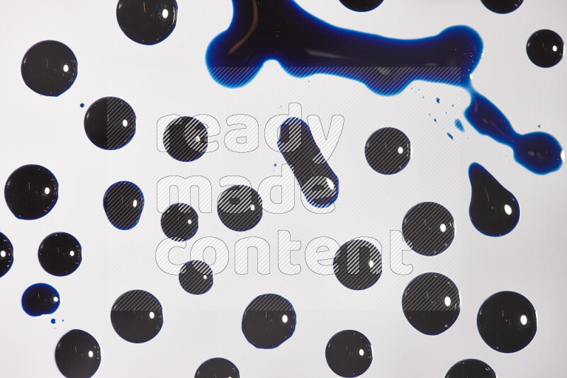 Close-ups of abstract blue paint droplets on the surface