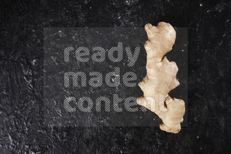 Fresh ginger root on black background