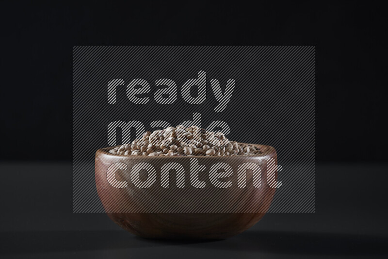 Black-eyed peas in a wooden bowl on grey background