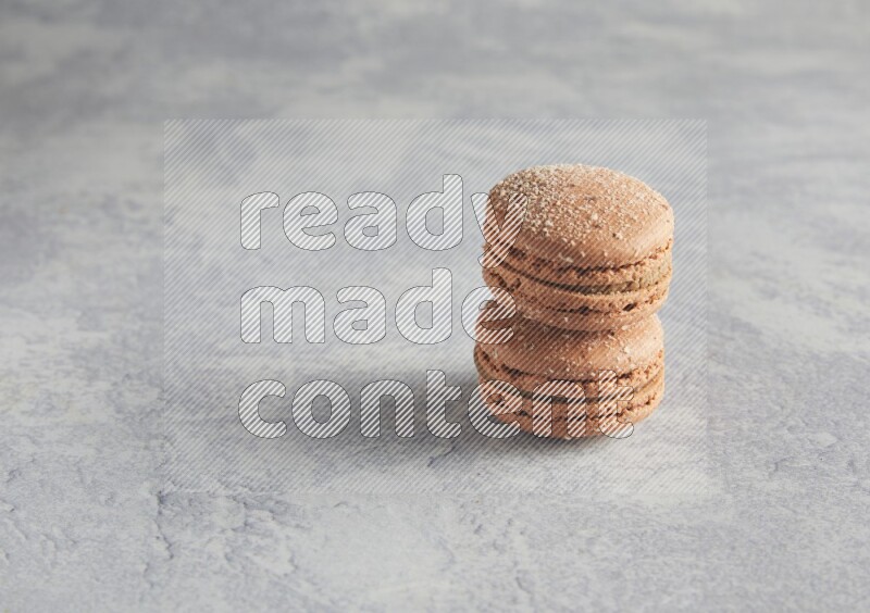 45º Shot of two Brown Hazelnuts macarons  on white  marble background