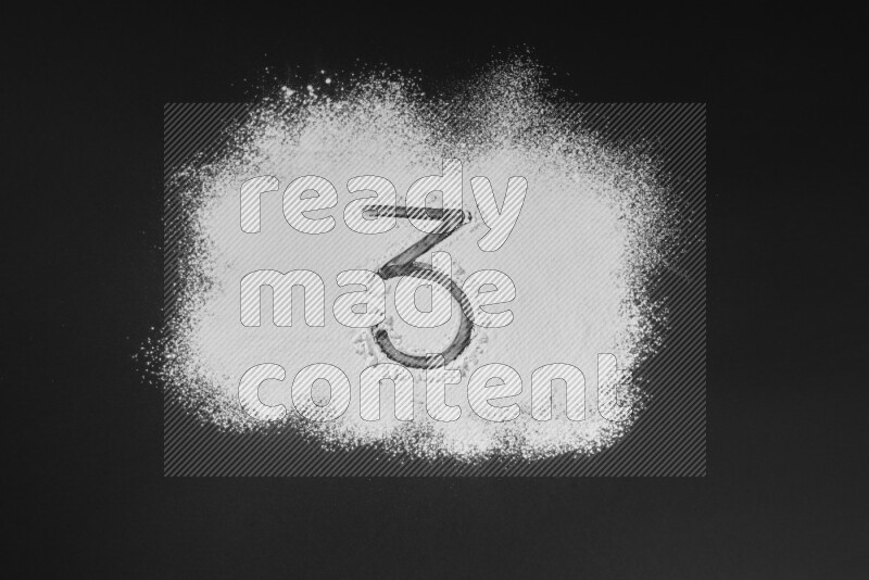 Numbers written with powder on black background