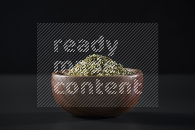 Freekeh in a wooden bowl on grey background