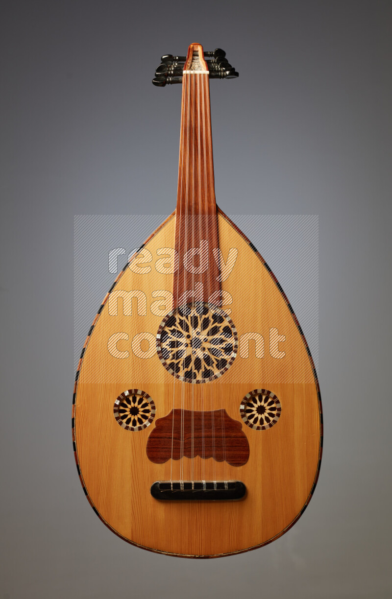 a wooden brown Oud on a gray background