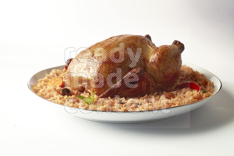 red basmati Rice with whole roasted chicken on a white plate with a silver rim direct on white background
