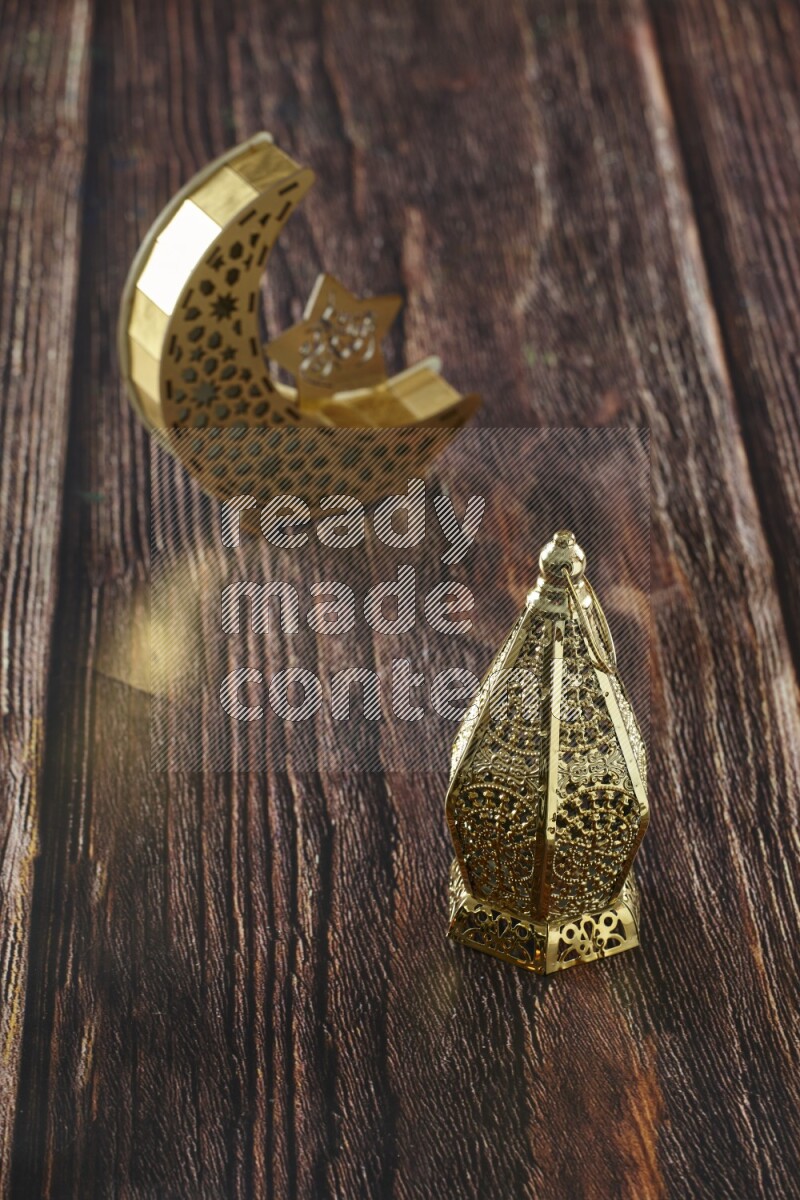 A wooden crescent lantern with classic ramadan lantern on brown wooden background
