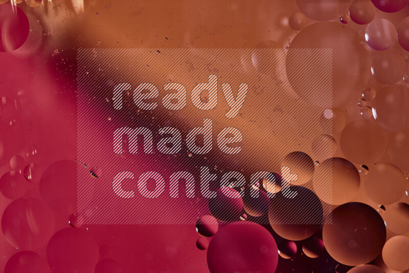 Close-ups of abstract oil bubbles on water surface in shades of red and orange
