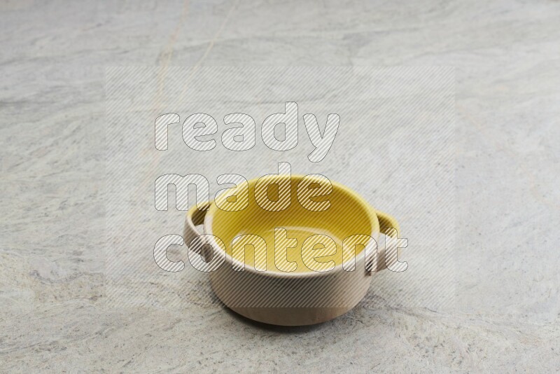 A multicolored pottery bowl on grey marble background