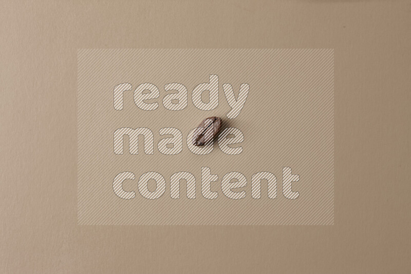 Roasted coffee beans on beige background