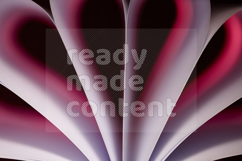 An abstract art piece displaying smooth curves in pink gradients created by colored light