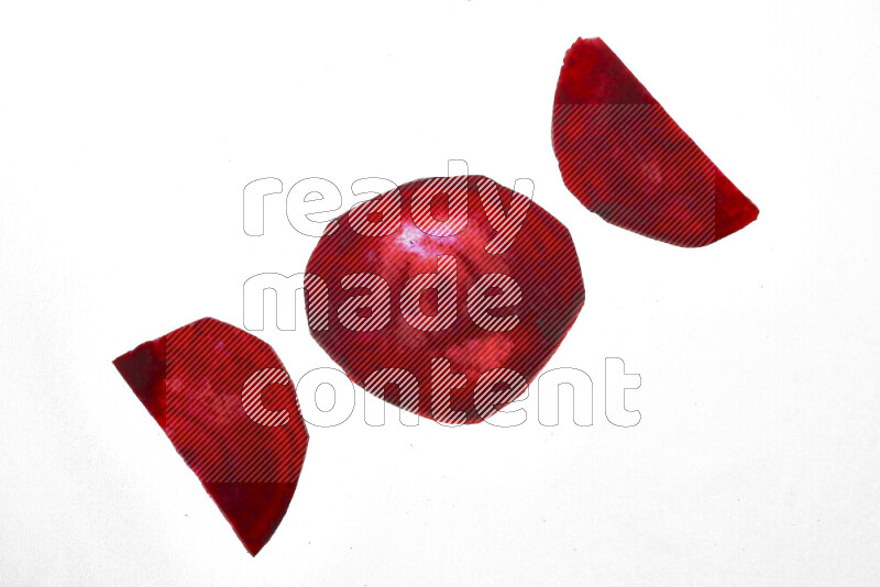 Beet slices on illuminated white background