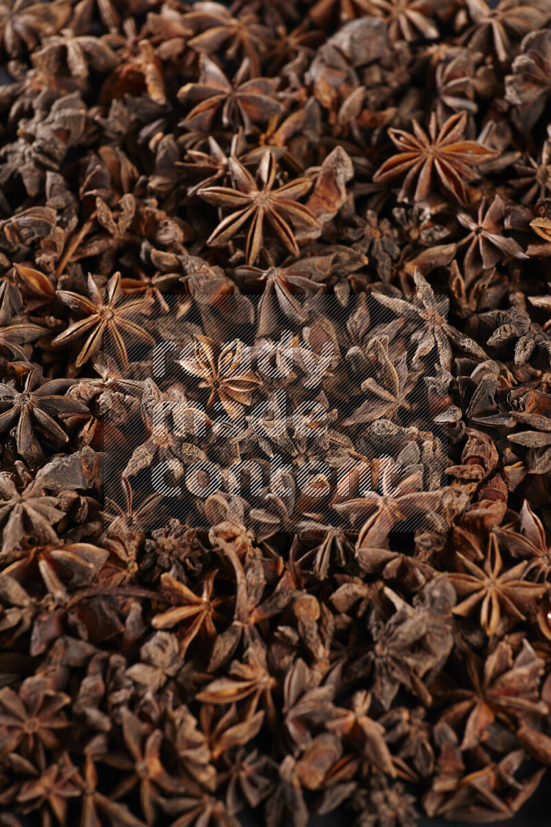 Star Anise fill the frame on black flooring