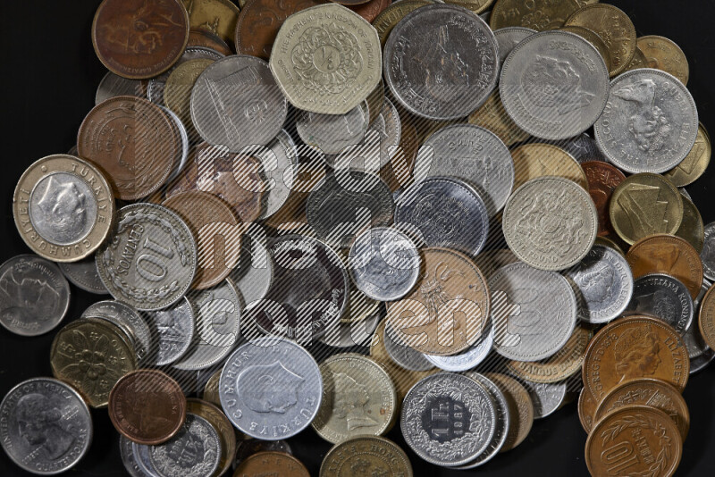 A close-ups of random old coins on black background