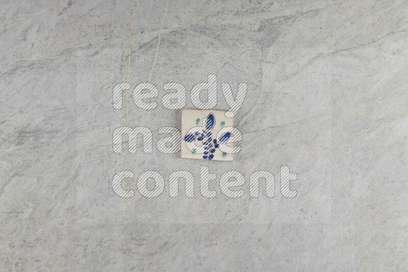 A decorative pottery coaster on grey marble background
