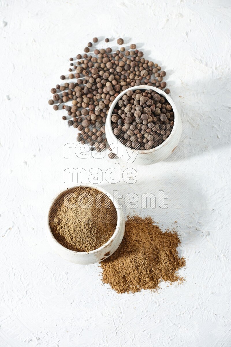 2 beige bowls, one full of powder and the other full of whole balls with balls and powder spreaded on a textured white flooring