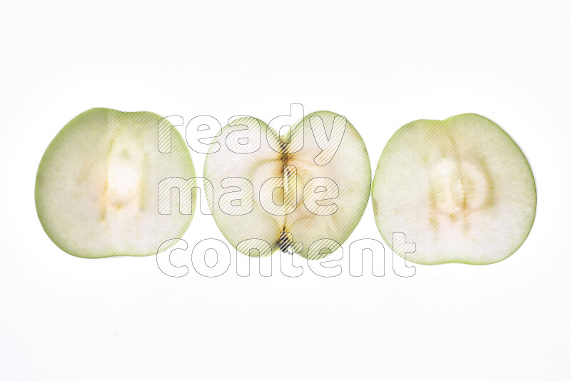 Apple slices on illuminated white background