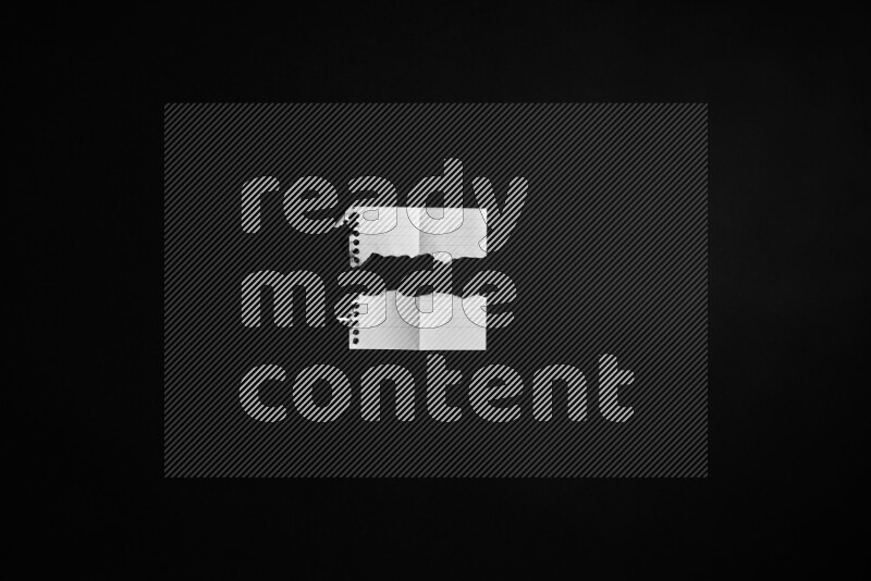Ripped notebook sheet on black background