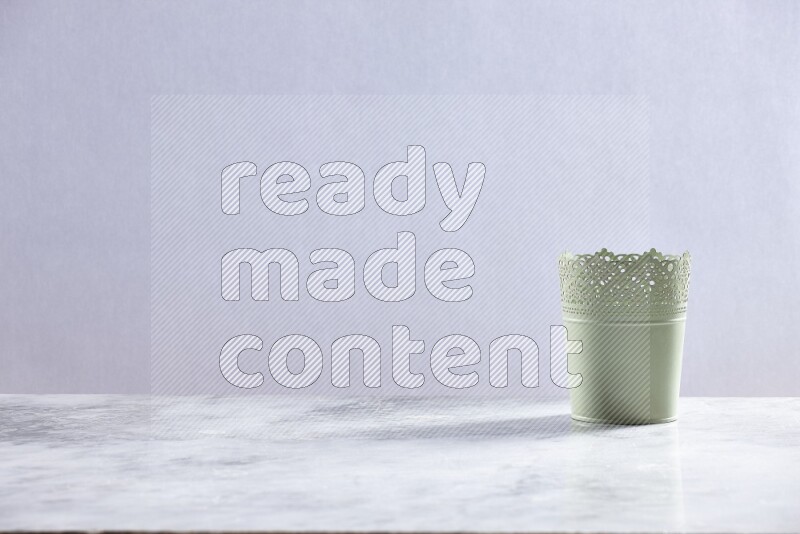 An empty green plant pot on grey marble background