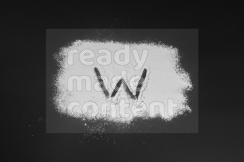 Alphabets written with powder on black background