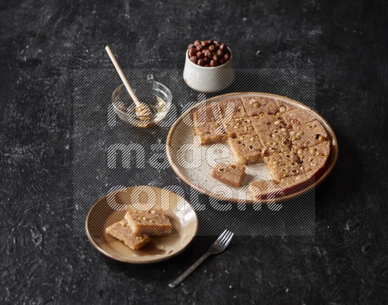Basbousa with nuts and honey in a dark setup