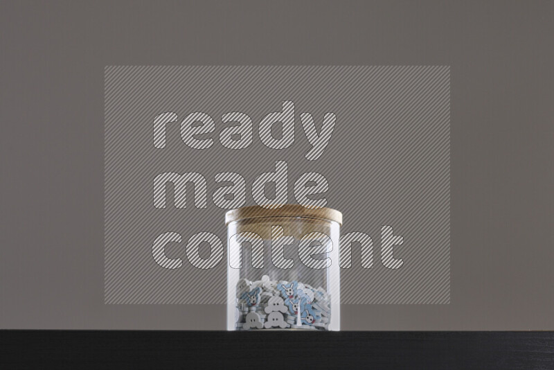 Buttons in a glass jar on black background