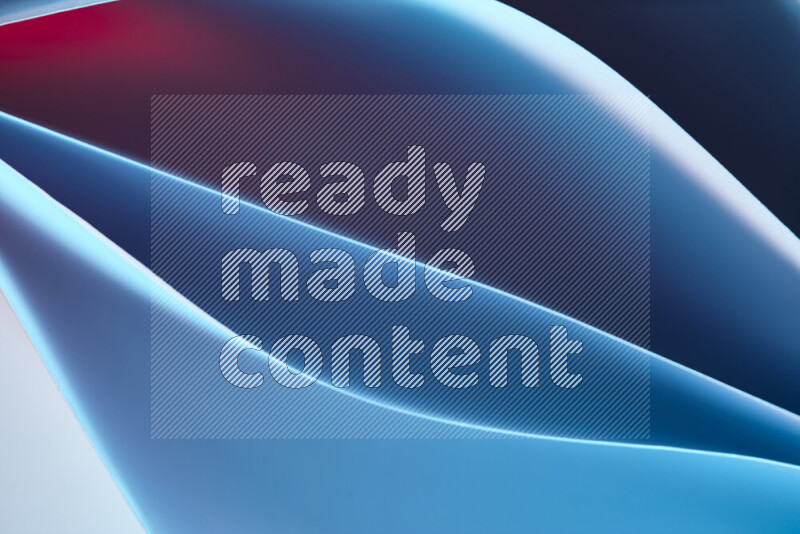 This image showcases an abstract paper art composition with paper curves in blue and red gradients created by colored light