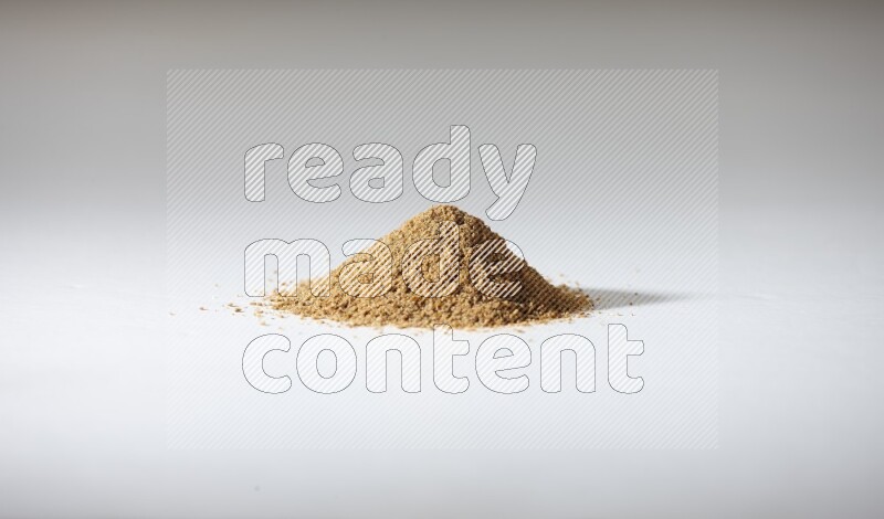 Cumin powder on white flooring